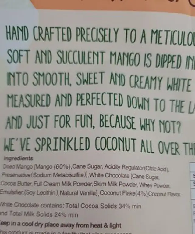 Half dipped mango with chocolate and  sprinkle of coconut ingredients label